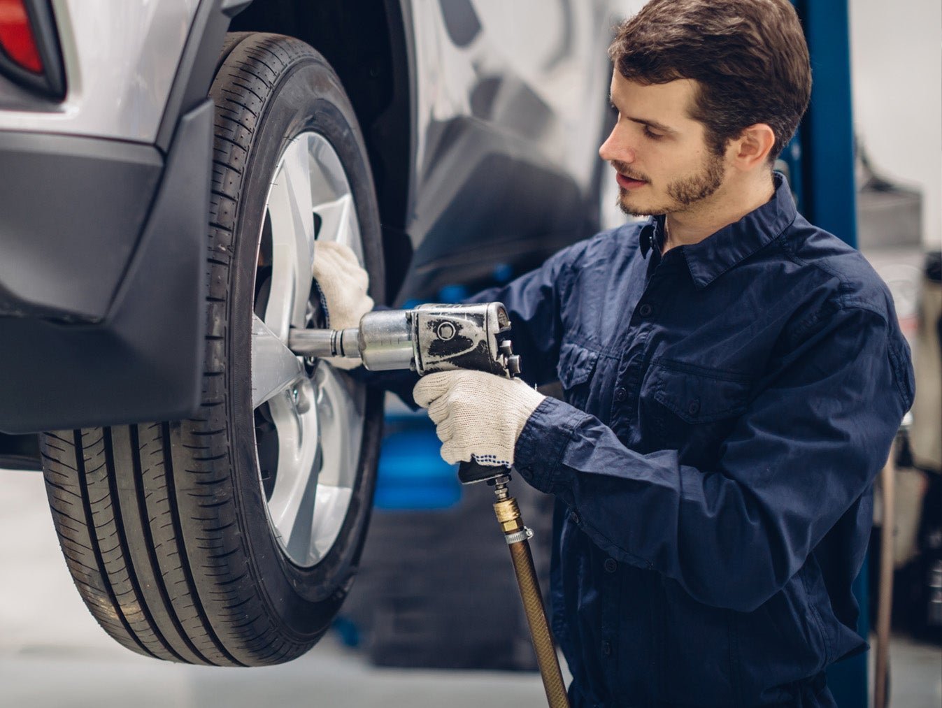 Image of INFINITI service technician taking notes on a vehicle.
